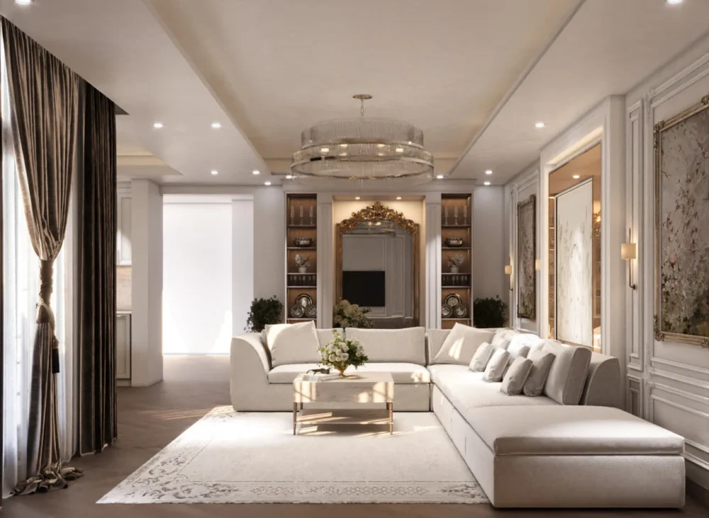 تصميم صالة معيشة مفتوحة على الطراز الفرنسي المعاصر من تنفيذ TELA Architects، تضم كنب زاوية فاخر (L-shape)، ثريا مودرن دائرية، جدران بالبانوهات الكلاسيكية البيضاء، وأرضيات خشبية هيرينغبون في فيلا سكنية بجدة.