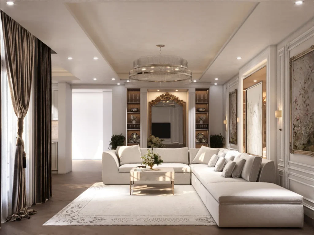 تصميم صالة معيشة مفتوحة على الطراز الفرنسي المعاصر من تنفيذ TELA Architects، تضم كنب زاوية فاخر (L-shape)، ثريا مودرن دائرية، جدران بالبانوهات الكلاسيكية البيضاء، وأرضيات خشبية هيرينغبون في فيلا سكنية بجدة.