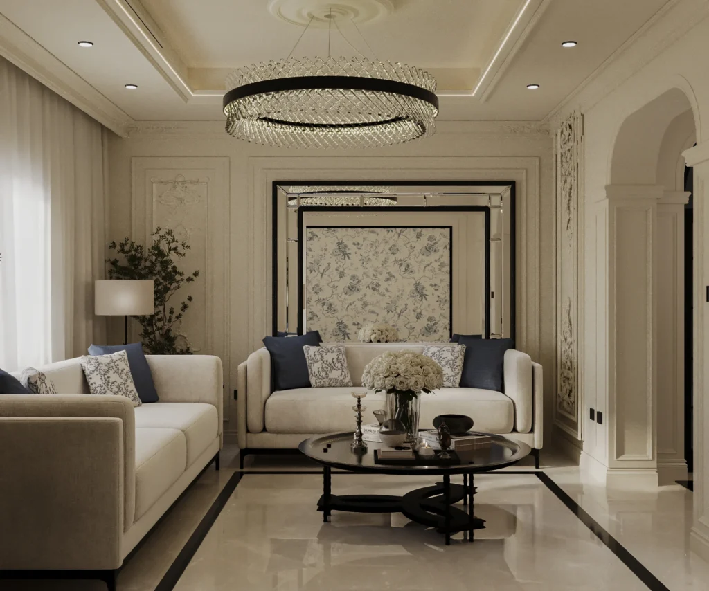 تصميم مجلس فاخر بطراز فرنسي حديث من ابتكار TELA Architects، تظهر فيه ثريا كريستال دائرية ضخمة، أرائك بيضاء مع وسائد كحلي، ومرايا جدارية ممتدة تمنح شعوراً بالرحابة.
